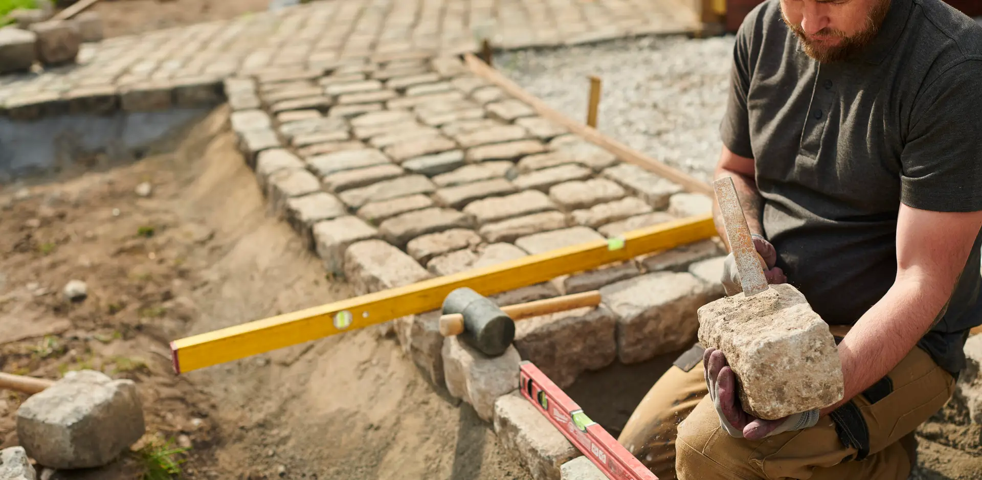 Professional installation of natural stone paving on the construction site